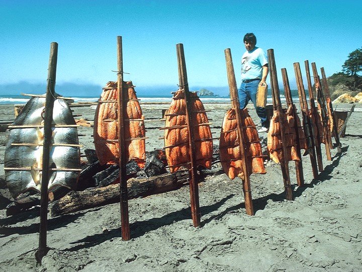 Traditional Tribal method of smoking salmon, on a beach.