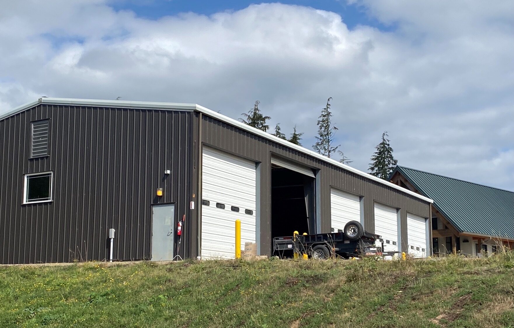 A photograph of a five-bay corrugated steel garage